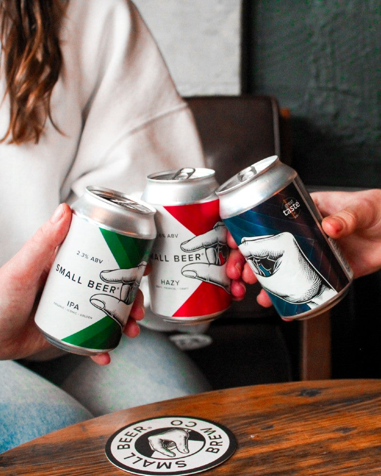 Three Small Beer cans in a pub